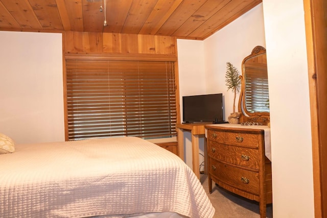 bedroom with wood walls, carpet floors, and wooden ceiling