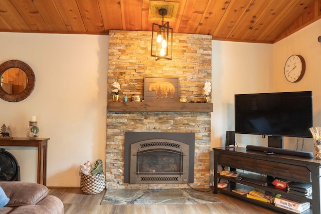 living room with hardwood / wood-style flooring, wood ceiling, and a fireplace