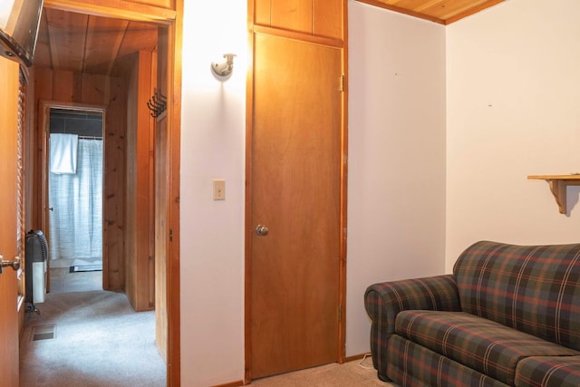 living area with light colored carpet and wooden ceiling