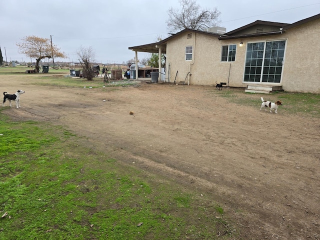 rear view of house with stucco siding