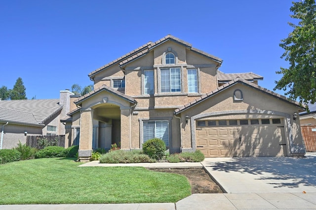 view of front of property with a front yard and a garage