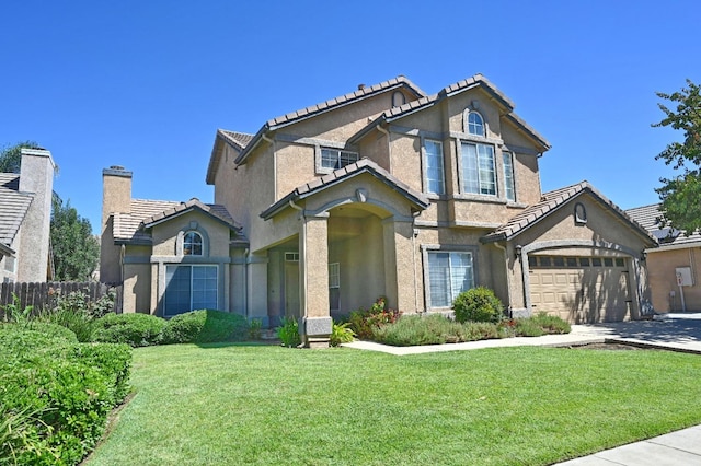 view of front facade featuring a garage and a front lawn