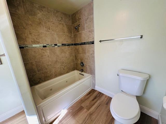 975 N Princeton Ave, Coalinga, CA 93210 - bathroom with tiled shower / bath, wood-type flooring, and toilet