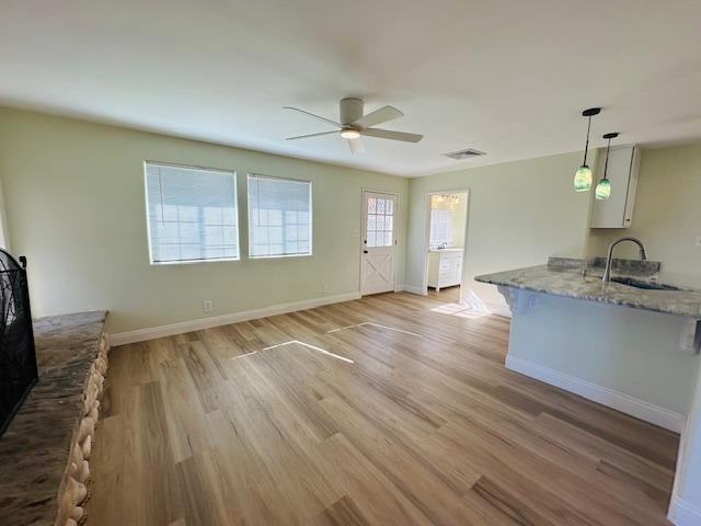 975 N Princeton Ave, Coalinga, CA 93210 - unfurnished living room featuring sink, ceiling fan, and light wood-type flooring