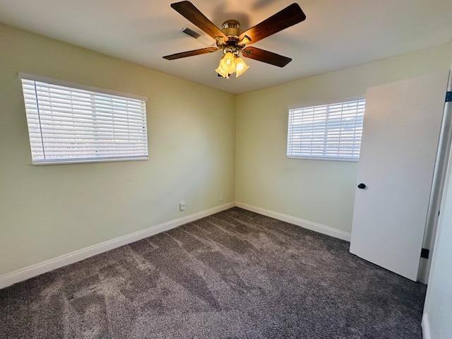 975 N Princeton Ave, Coalinga, CA 93210 - spare room featuring ceiling fan and dark colored carpet
