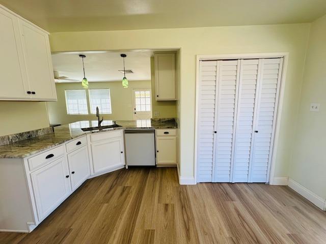975 N Princeton Ave, Coalinga, CA 93210 - kitchen featuring pendant lighting, white cabinetry, dishwasher, sink, and kitchen peninsula