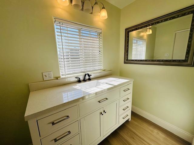 975 N Princeton Ave, Coalinga, CA 93210 - bathroom featuring vanity and hardwood / wood-style floors