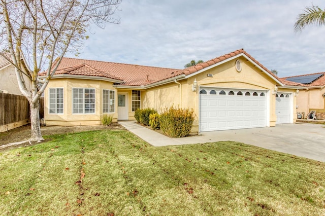 mediterranean / spanish home featuring a garage and a front lawn