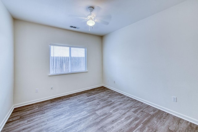 unfurnished room with hardwood / wood-style flooring and ceiling fan