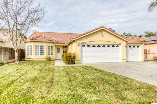 mediterranean / spanish house featuring a garage and a front yard