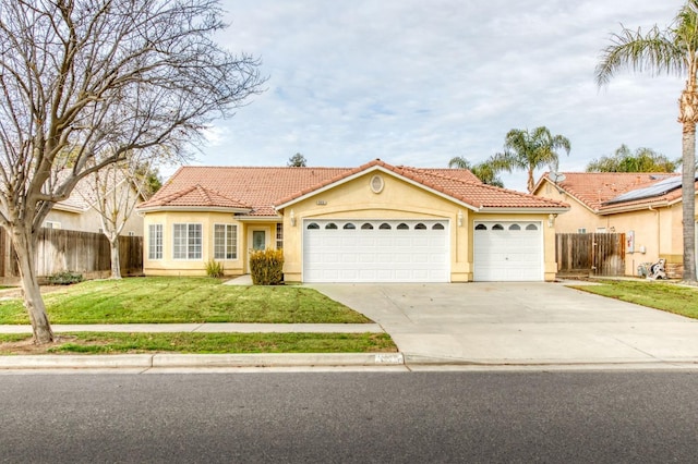 view of front of home with a front lawn and a garage