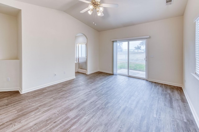 spare room with ceiling fan, lofted ceiling, and light wood-type flooring