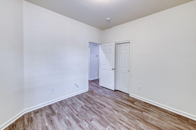 unfurnished bedroom with light wood-type flooring