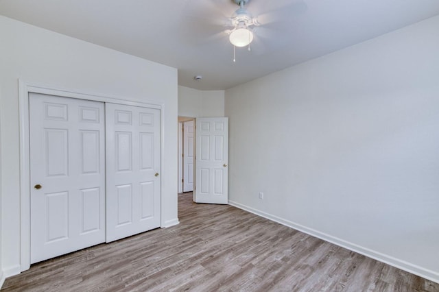 unfurnished bedroom with a closet, ceiling fan, and light hardwood / wood-style flooring