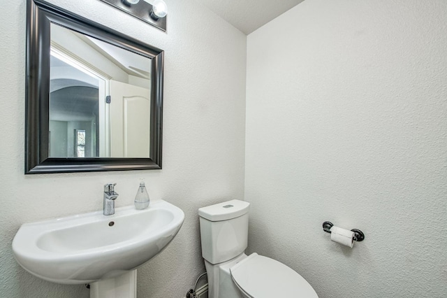 bathroom featuring sink and toilet