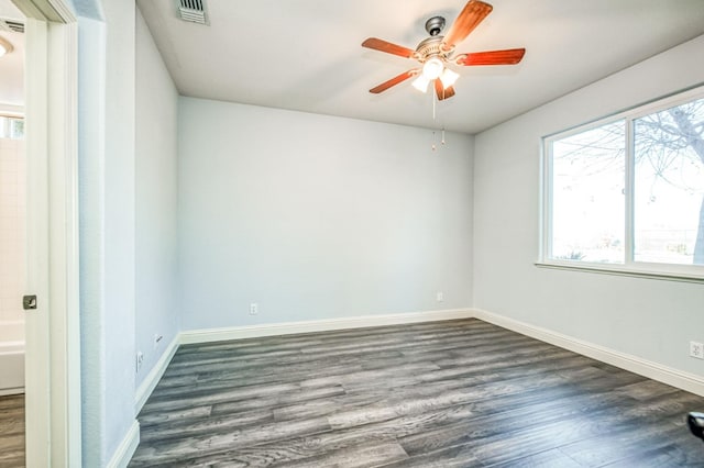 spare room featuring ceiling fan and dark hardwood / wood-style floors