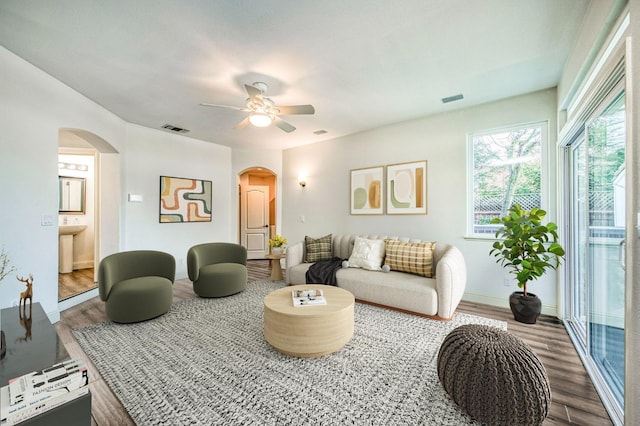 living room featuring wood-type flooring and ceiling fan