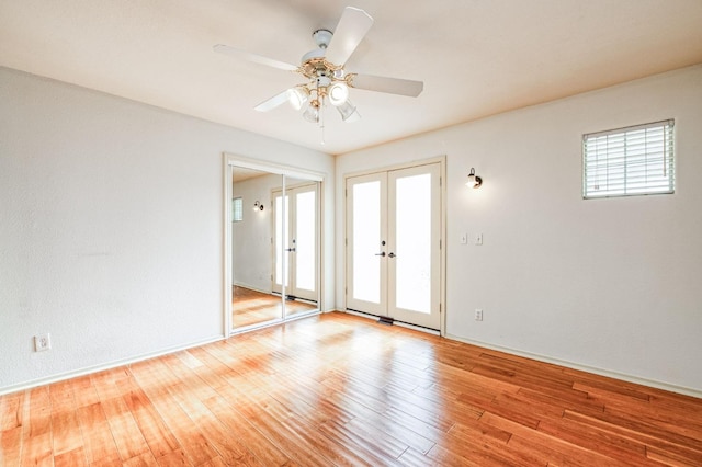 unfurnished room with french doors, ceiling fan, and light hardwood / wood-style floors