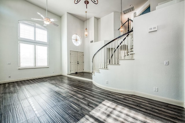 entrance foyer with a high ceiling, wood-type flooring, and ceiling fan