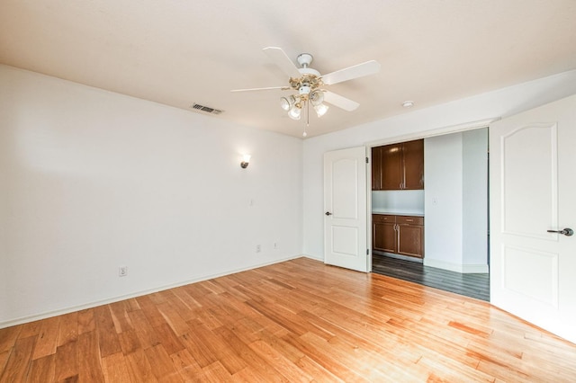 unfurnished room with ceiling fan and light hardwood / wood-style flooring