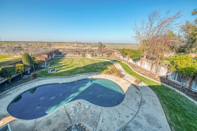 view of pool with a yard