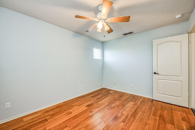 spare room featuring light hardwood / wood-style flooring and ceiling fan