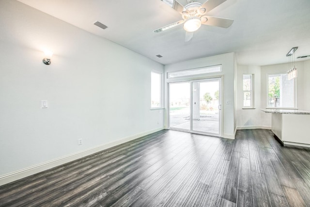 empty room with dark wood-type flooring and ceiling fan