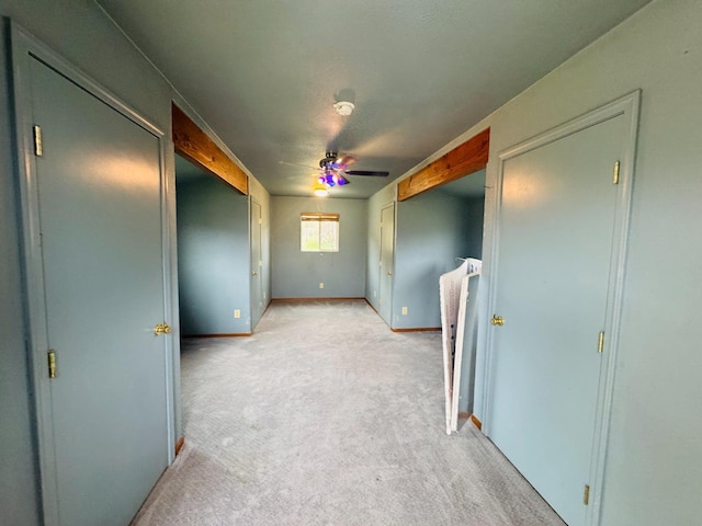 spare room featuring ceiling fan and light colored carpet