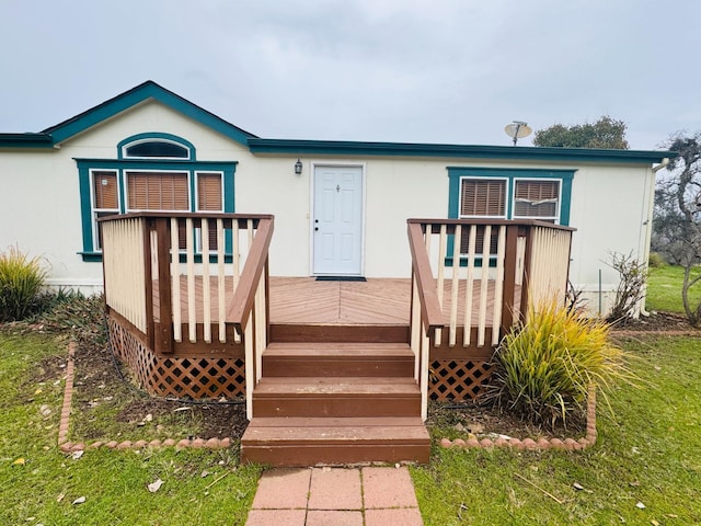 rear view of property with a wooden deck