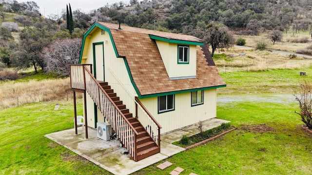 exterior space featuring a yard and ac unit