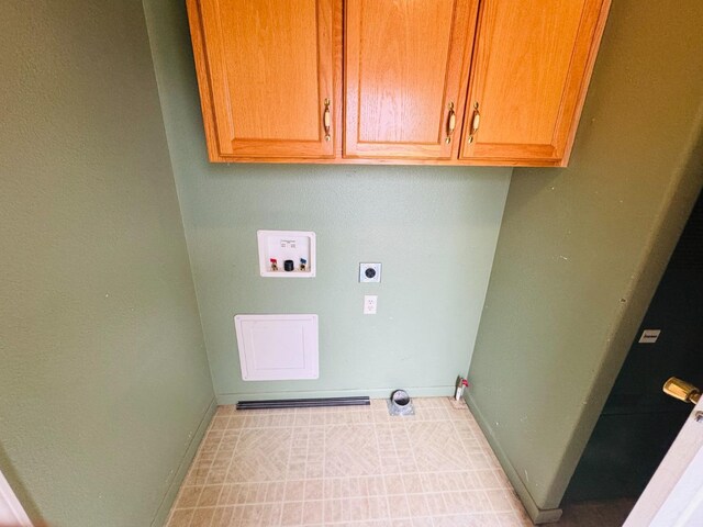 clothes washing area featuring cabinets, hookup for a washing machine, and hookup for an electric dryer