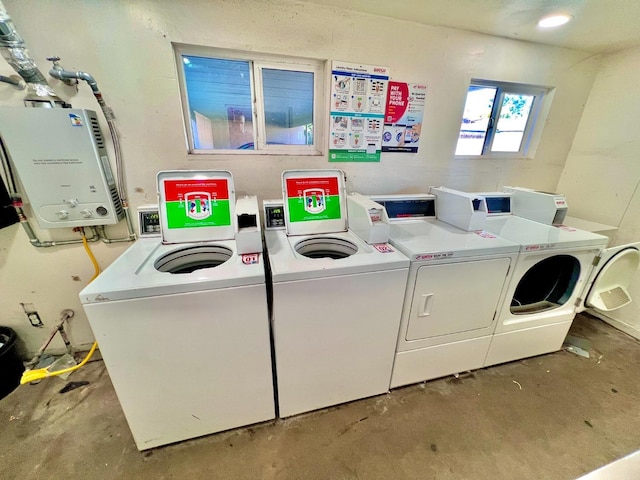 washroom with tankless water heater and independent washer and dryer