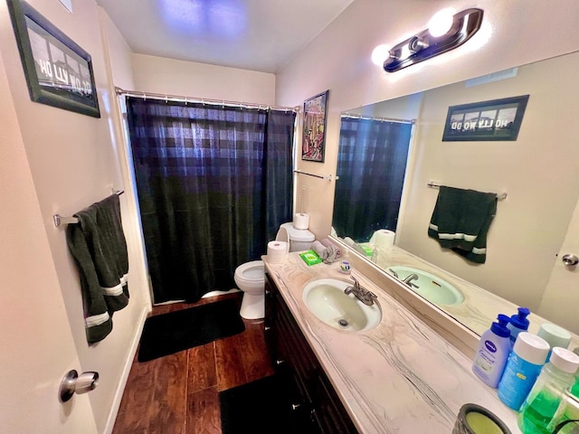 bathroom featuring hardwood / wood-style floors, toilet, vanity, and a shower with shower curtain