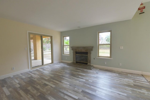 unfurnished living room with a wealth of natural light and light wood-type flooring