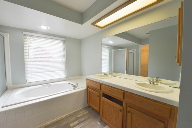 bathroom with shower with separate bathtub, vanity, and hardwood / wood-style flooring