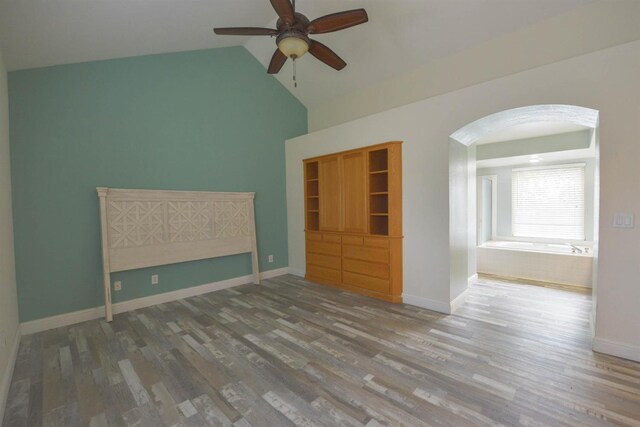 spare room featuring hardwood / wood-style flooring, ceiling fan, and vaulted ceiling