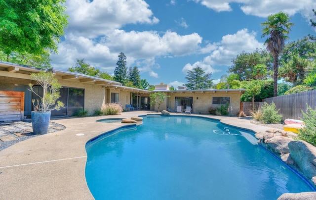 view of pool with an in ground hot tub