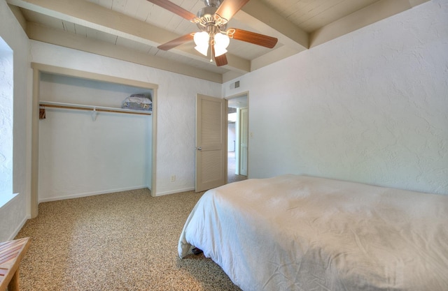 bedroom featuring beam ceiling, ceiling fan, a closet, and carpet floors