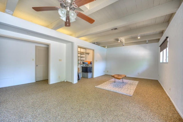 spare room featuring carpet flooring, beam ceiling, track lighting, and ceiling fan