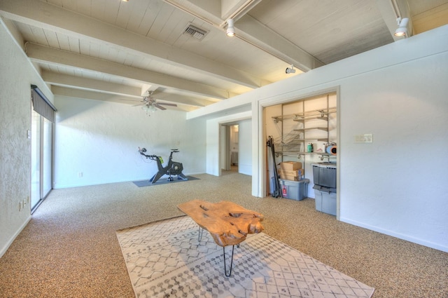 interior space with ceiling fan, beam ceiling, and light carpet