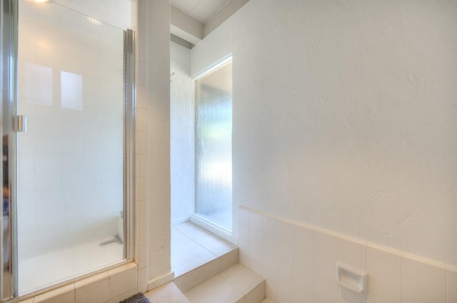 bathroom featuring tile patterned flooring and walk in shower