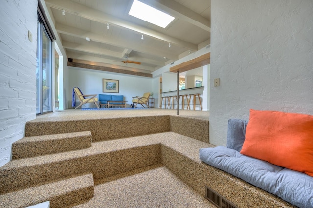 interior space featuring beamed ceiling and carpet