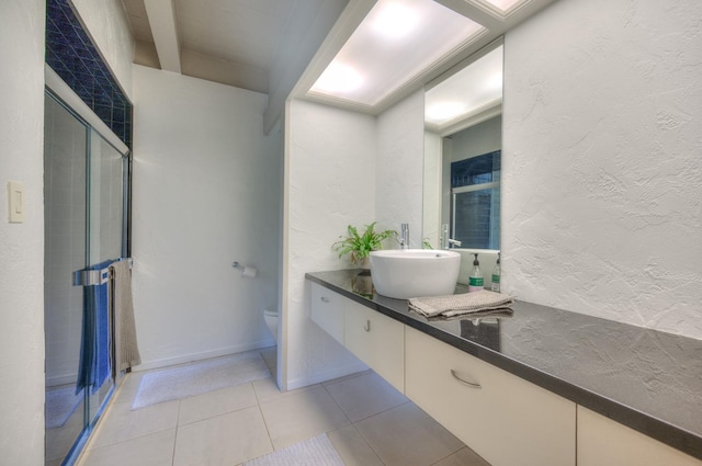 bathroom featuring tile patterned floors, walk in shower, vanity, and toilet