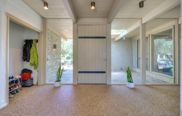 doorway featuring beam ceiling