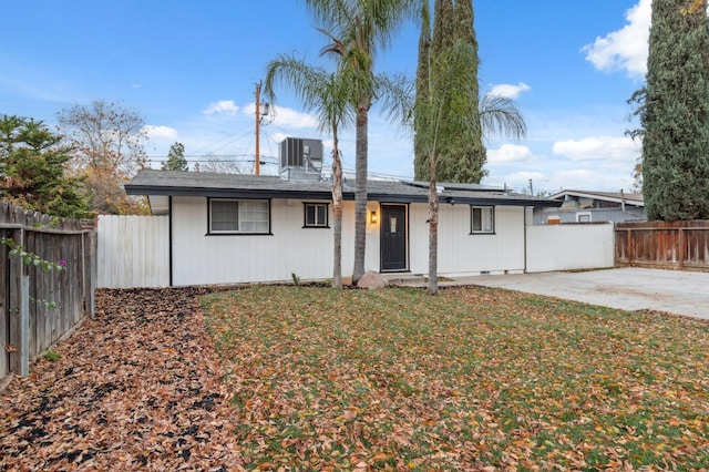 ranch-style home with cooling unit, a patio, and a front yard