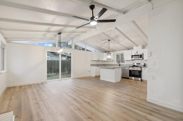 unfurnished living room with lofted ceiling with beams, ceiling fan, and light hardwood / wood-style floors