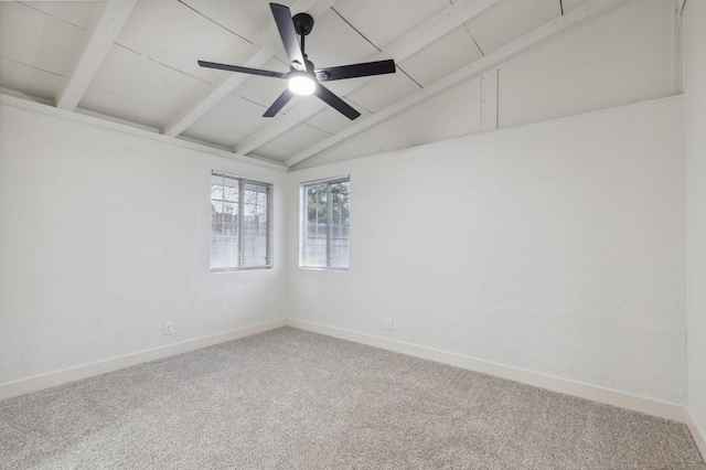 unfurnished room featuring lofted ceiling with beams, ceiling fan, and carpet