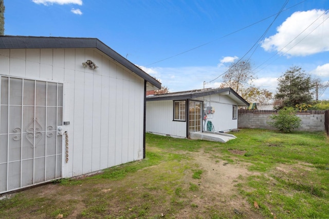 view of property exterior with a lawn