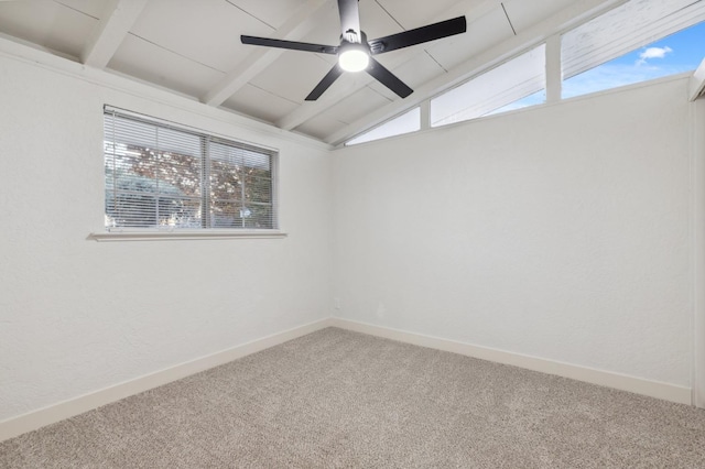 carpeted spare room with ceiling fan and vaulted ceiling with beams