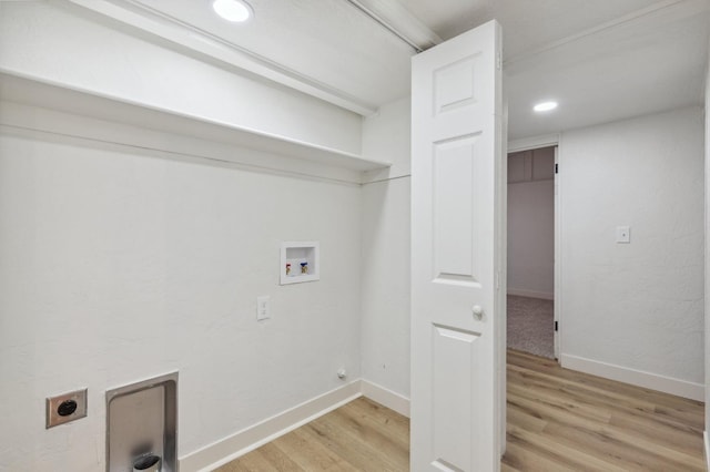 clothes washing area featuring hookup for a washing machine, light hardwood / wood-style floors, and electric dryer hookup